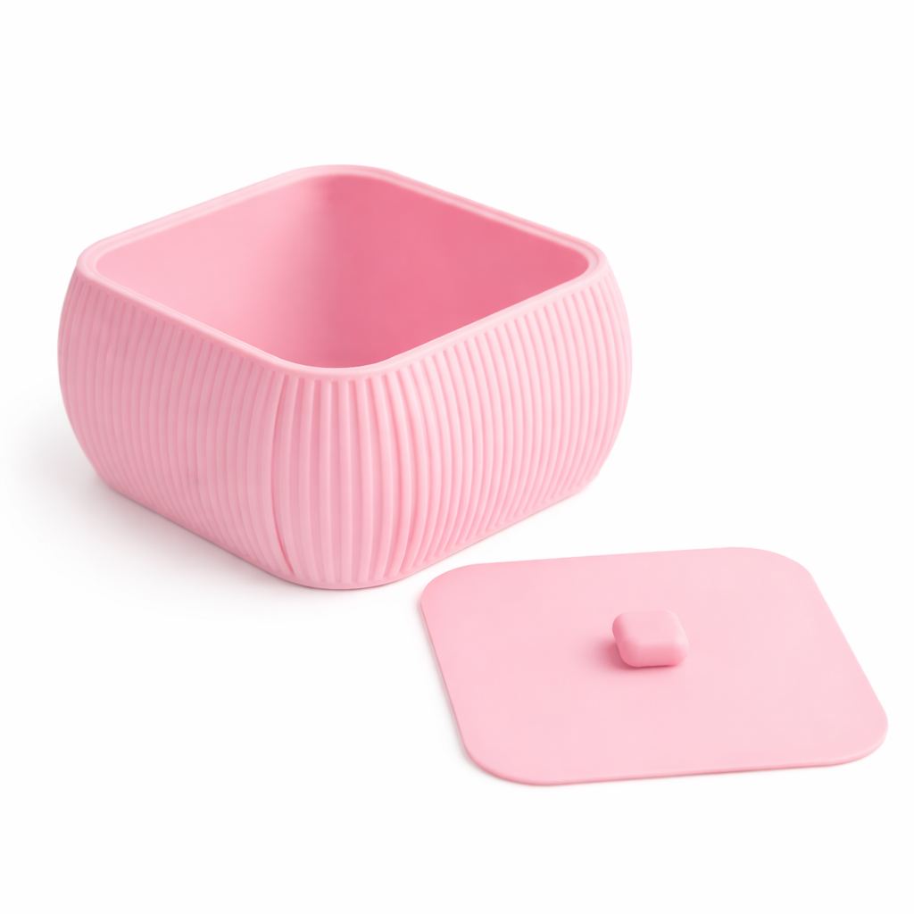 Pink silicone container with lid on a white background