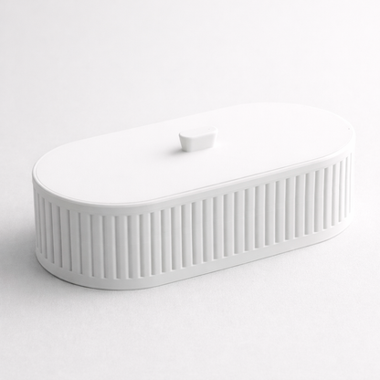 White ceramic sink with ribbed design on a white background