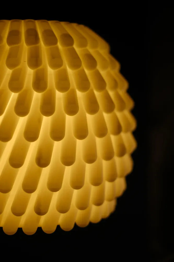 Close-up of a textured yellow surface with a dark background