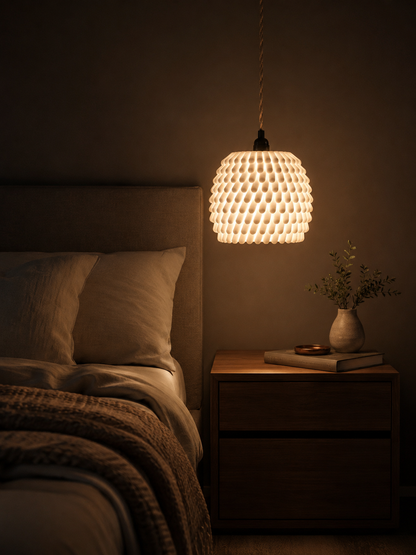 Bedroom with a textured pendant light, bed, and nightstand.