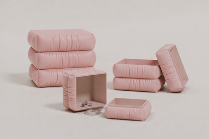 Set of pink quilted storage boxes on a light gray background