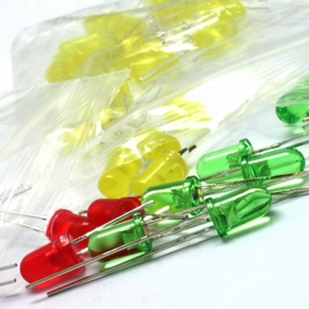 Assorted red, green, and yellow LEDs in a clear plastic bag on a white background