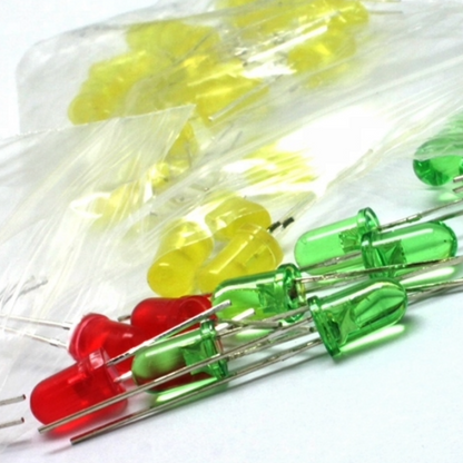 Assorted red, green, and yellow LEDs in a clear plastic bag on a white background