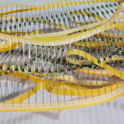 Close-up of a resistor stack with yellow bands on a white background