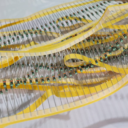 Close-up of a resistor strip with yellow bands on a white background