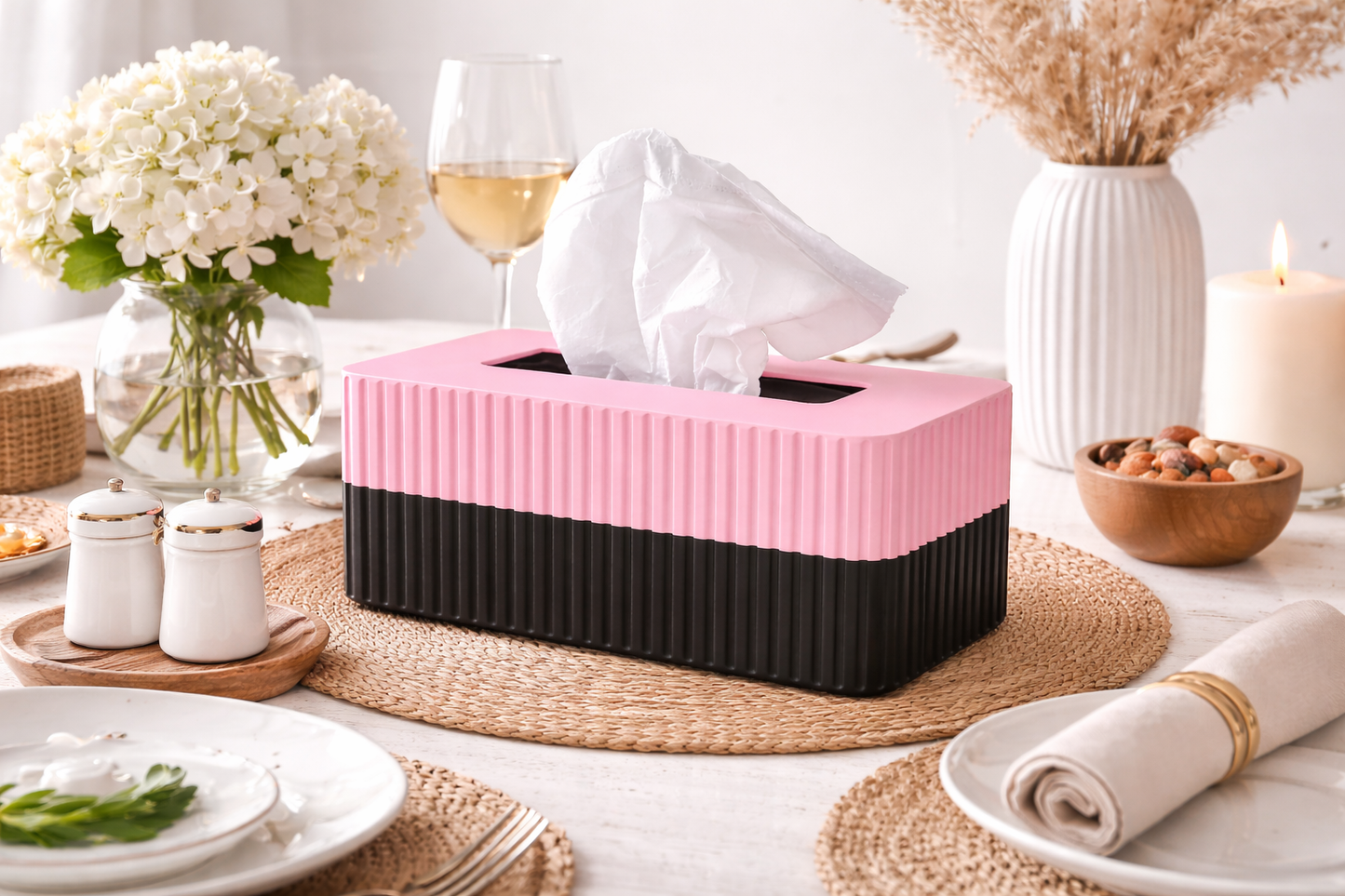 Pink and black tissue box on a table with dining setup