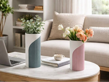 Two decorative vases with plants on a coffee table in a living room setting.
