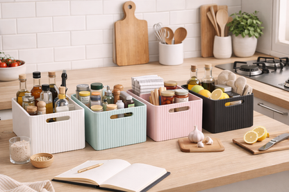 Kitchen counter with storage bins and kitchen items on a light-colored countertop.