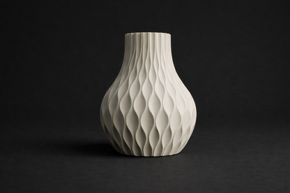 White ceramic vase with textured design on a black background