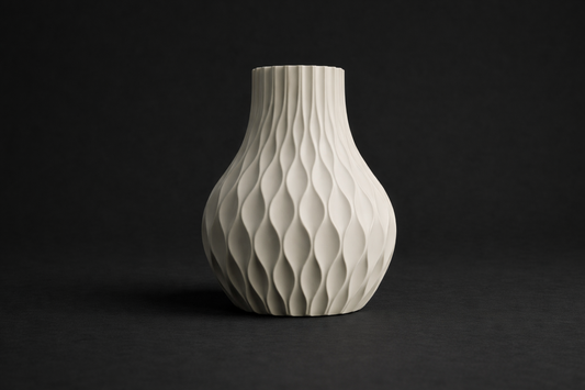 White ceramic vase with textured design on a black background