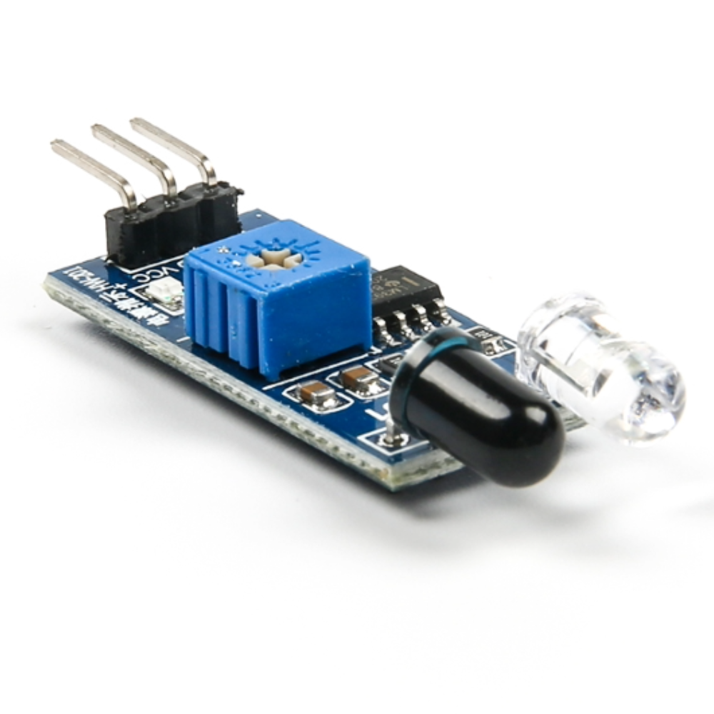 Electronic component board with a blue square component, black capsule, and clear crystal on a white background