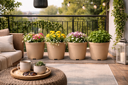 Outdoor patio with potted plants, a coffee table, and a view of trees.