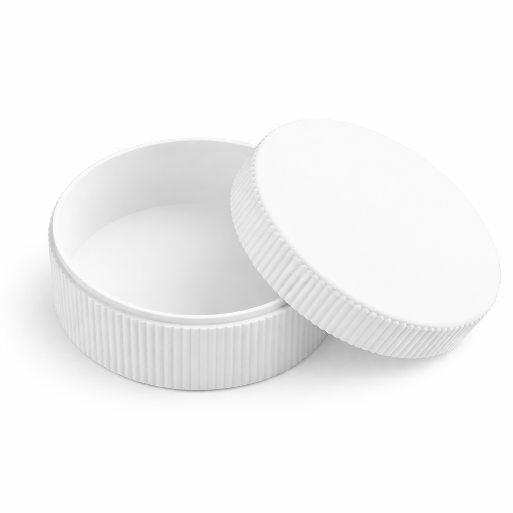 Two white plastic bottle caps on a white background