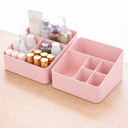 Pink cosmetic organizer with various small bottles on a light wooden surface.