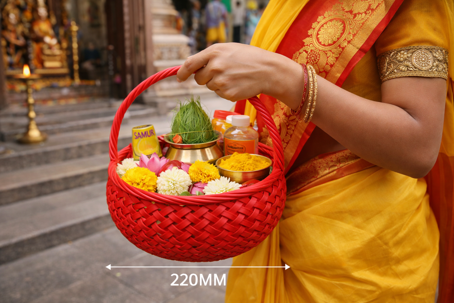 Person holding a red woven basket with offerings in front of a temple.