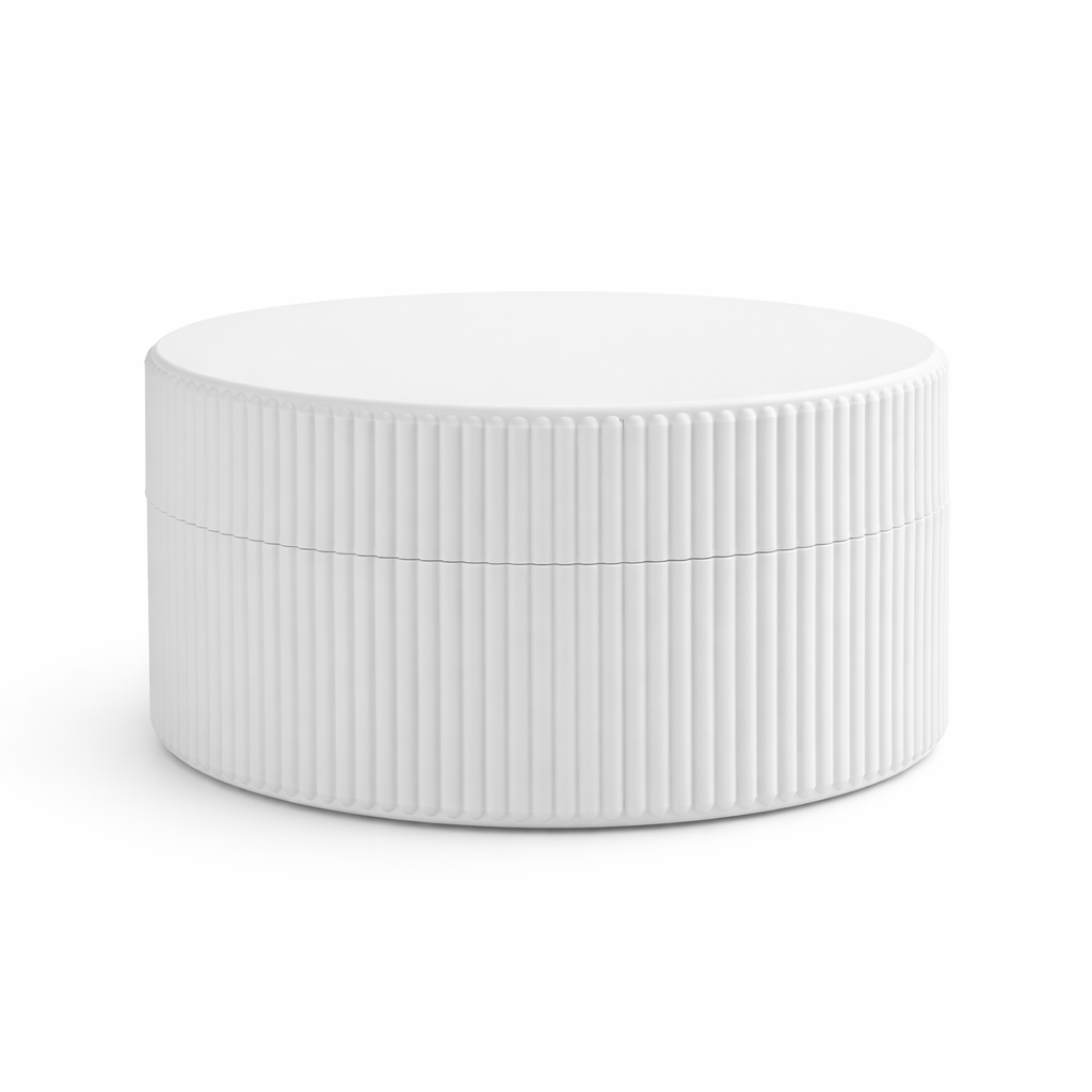 White ceramic bowl with ribbed texture on a white background