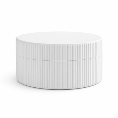 White ceramic bowl with ribbed texture on a white background