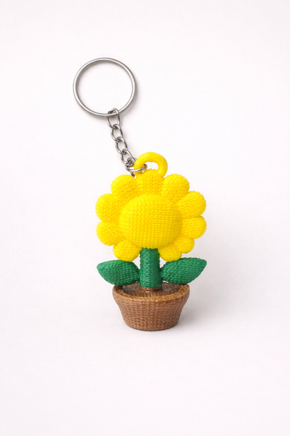Yellow sunflower keychain with a woven base on a white background