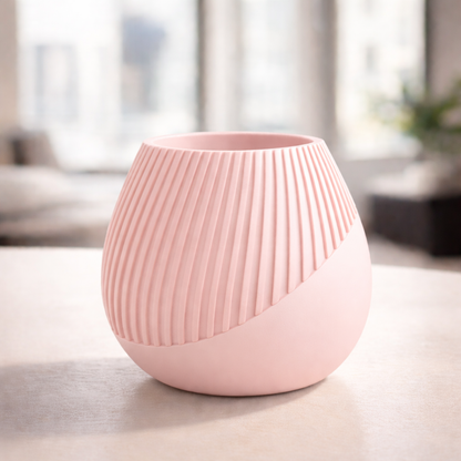 Pink ceramic vase on a table with a blurred indoor background