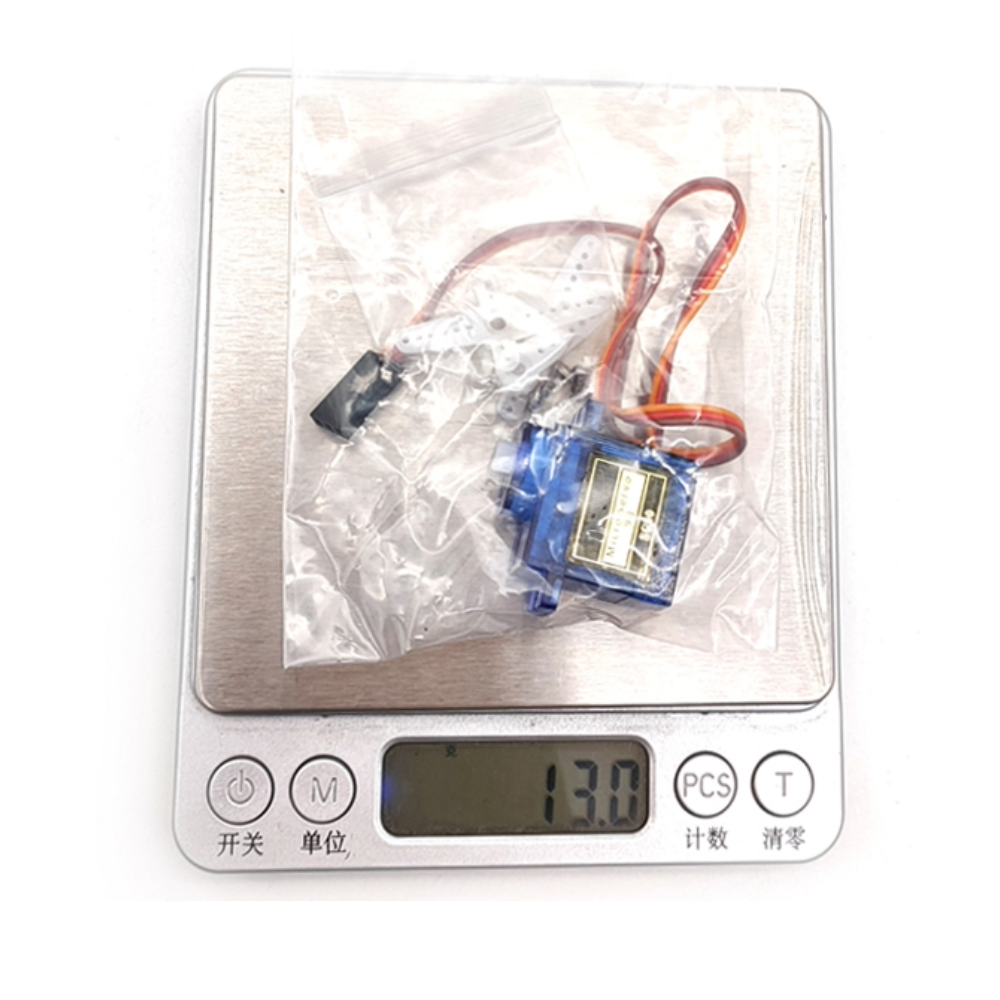 Small electronic component on a digital scale with a clear plastic bag.