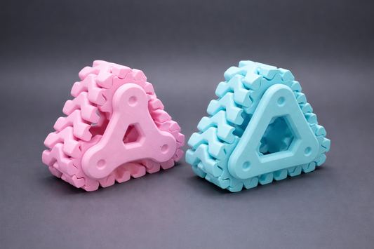 Pink and blue triangular textured objects on a gray background