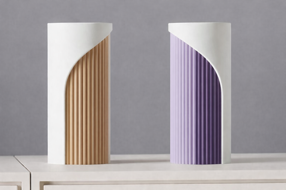 Two modern vases, one gold and one purple, on a gray background