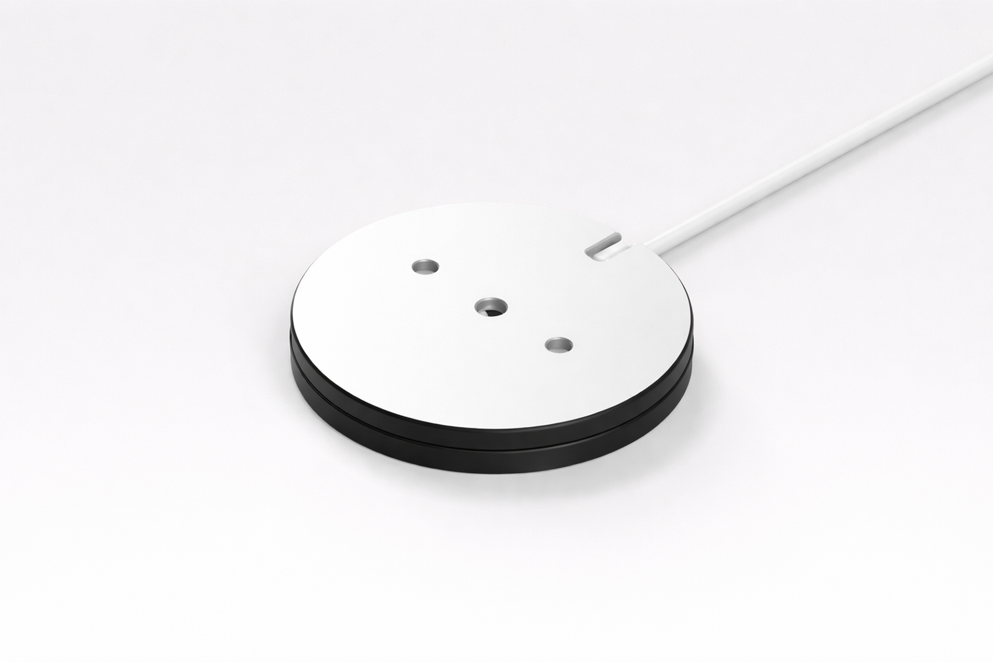 Round white object with black base on a white background