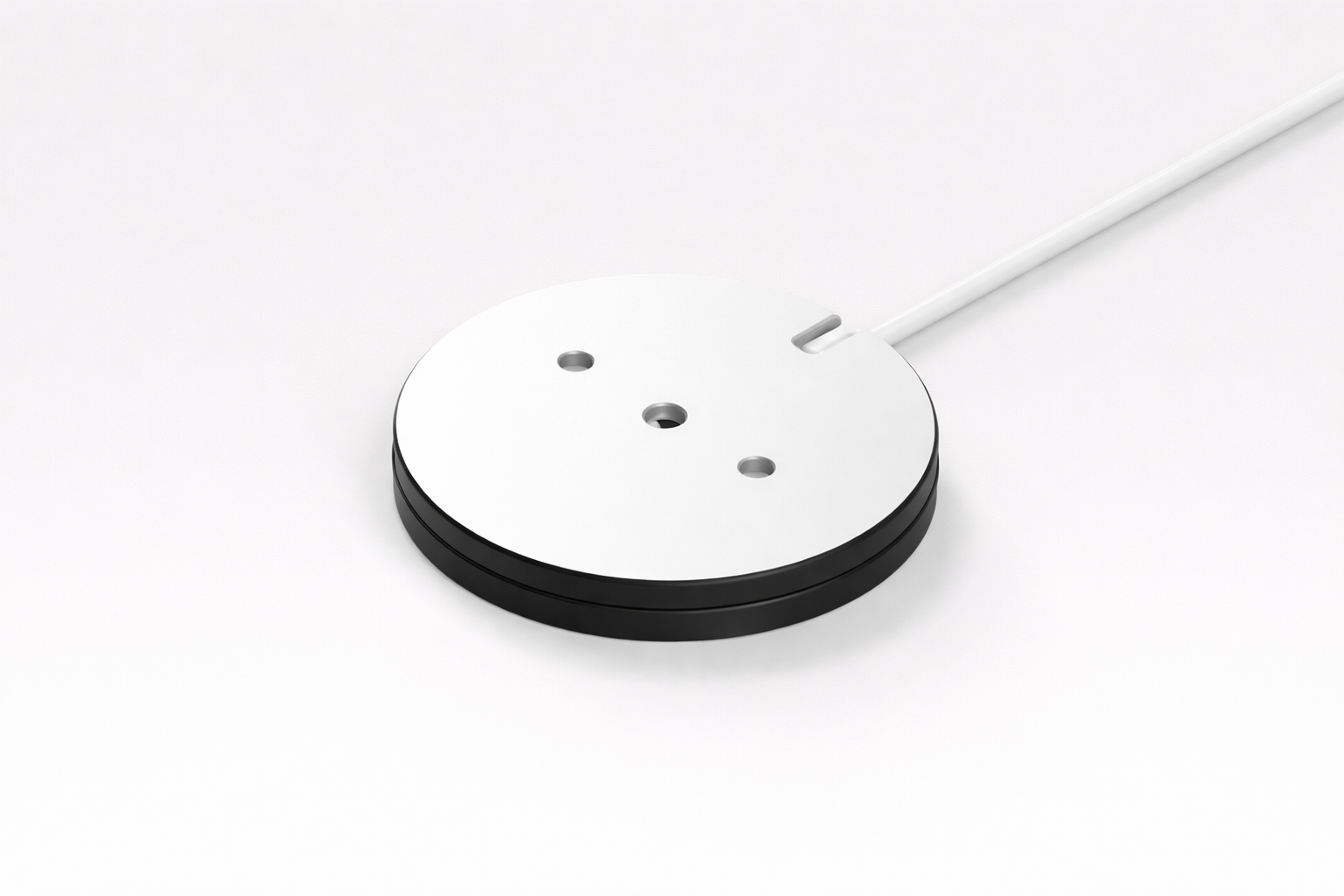 Round white object with black base on a white background