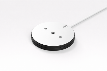 Round white object with black base on a white background