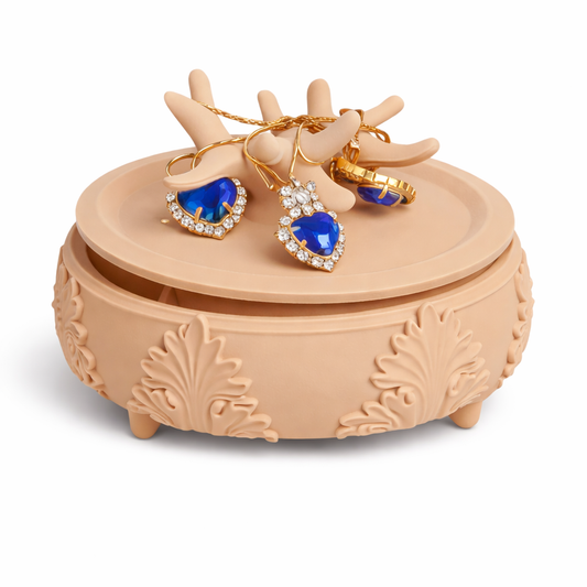 Decorative jewelry box with blue heart-shaped earrings on a white background