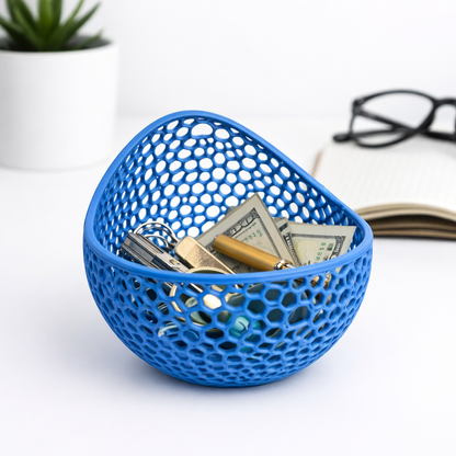 Blue mesh basket with keys and money on a white surface