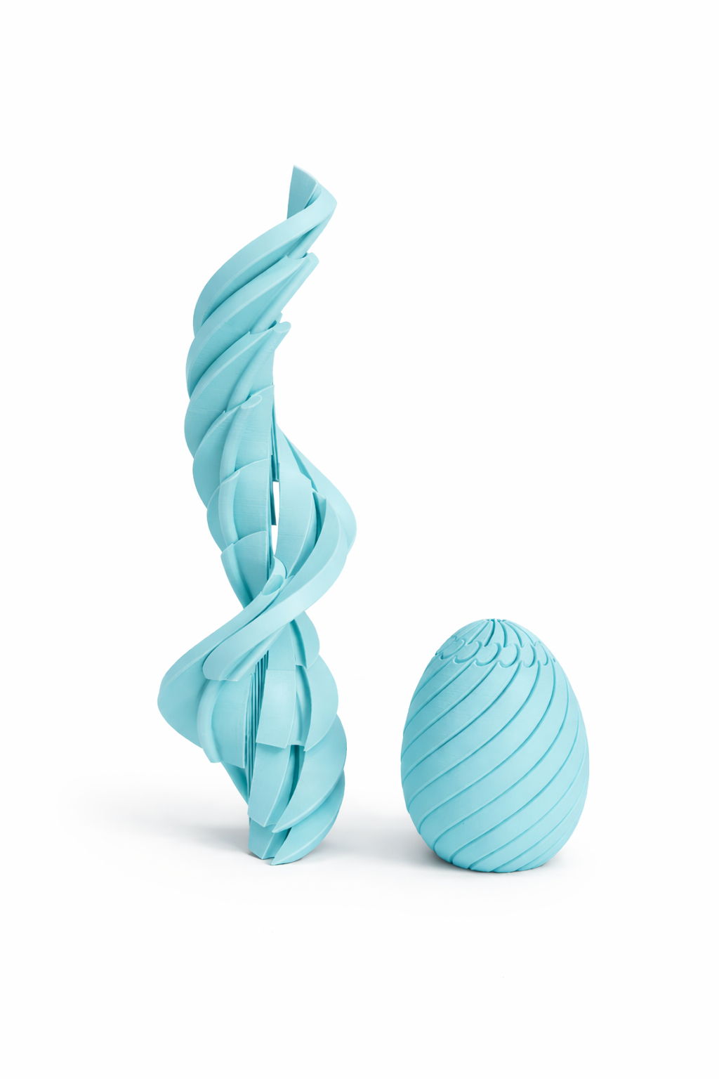 Two light blue dog toys, a twisted rope and a ball, on a white background