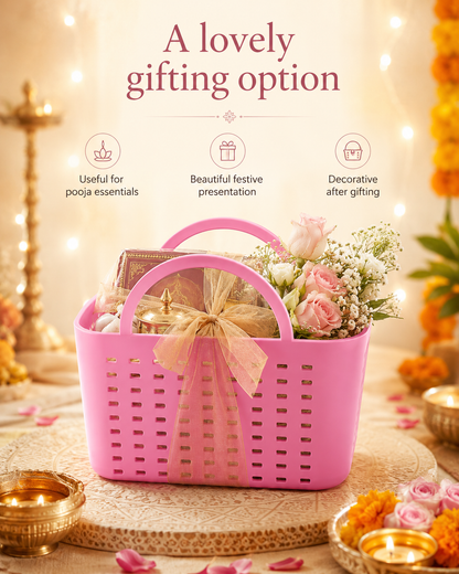 A pink plastic gift basket filled with flowers and packaged essentials, displayed on a decorated table with warm string lights and festive decor. Text above reads 'A lovely gifting option' with three feature icons.
