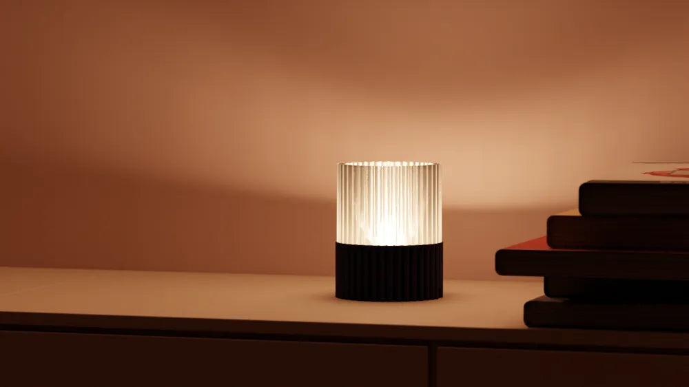 Modern table lamp with a ribbed design on a wooden surface against a warm brown background