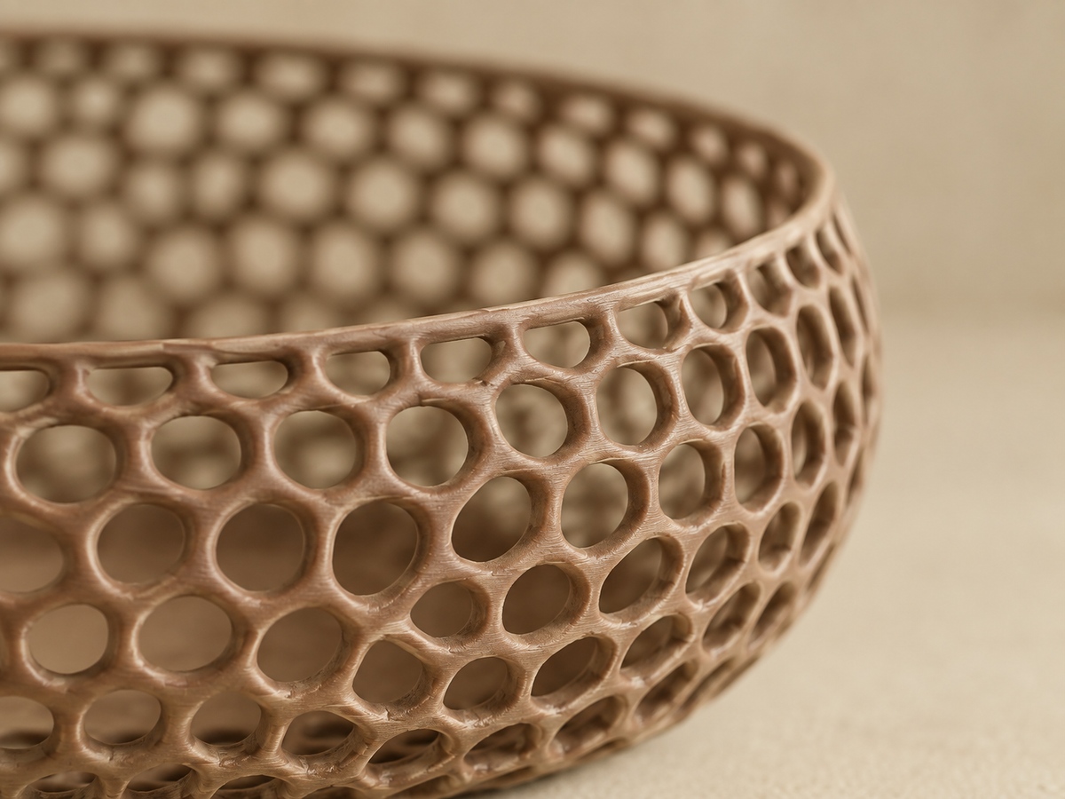 A close-up of a brown ceramic bowl with a honeycomb lattice pattern, set against a neutral beige background.