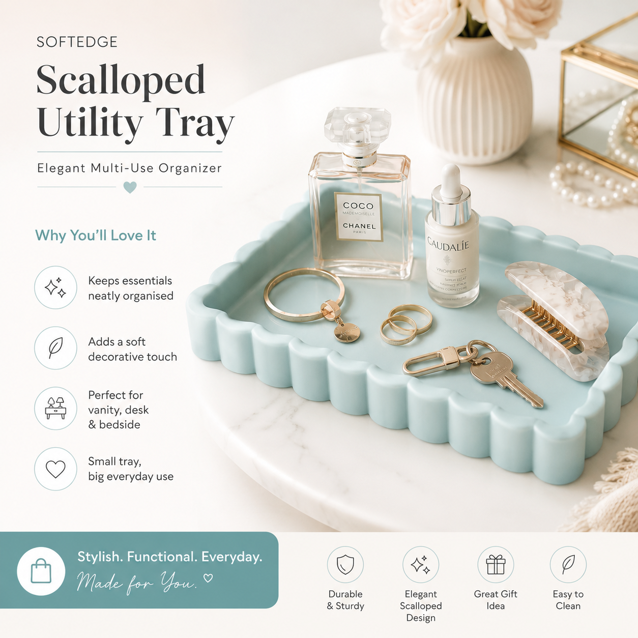 A light blue scalloped utility tray styled with perfume bottles, rings, keys, and a clutch on a white surface, with promotional text and feature icons around it.