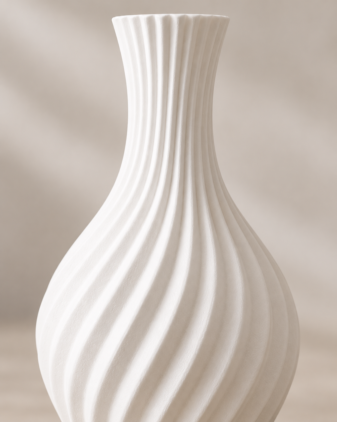 A white ceramic vase with a flared neck and a vertically ribbed, twisted spiral texture, shown against a soft beige background.