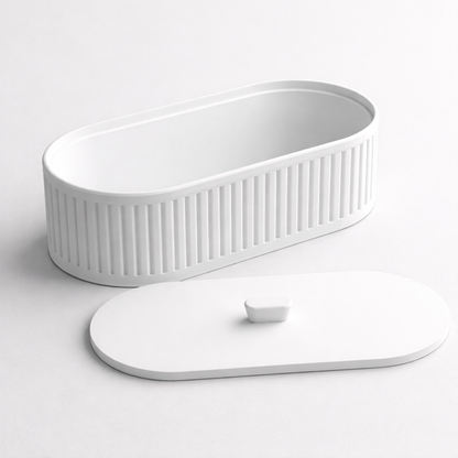 White electronic device with a ribbed surface on a light gray background