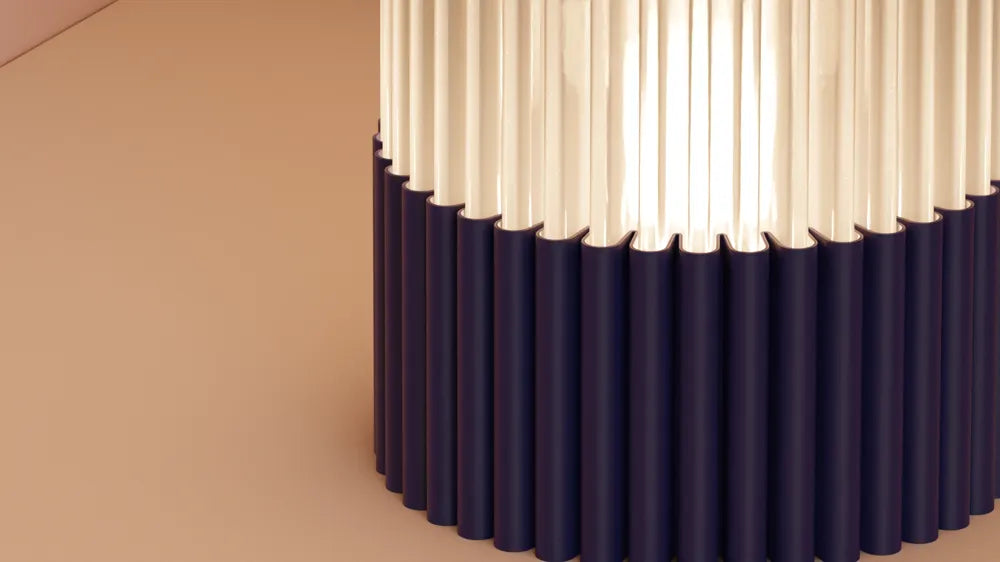 Close-up of a cylindrical lamp with white and navy design on a beige background