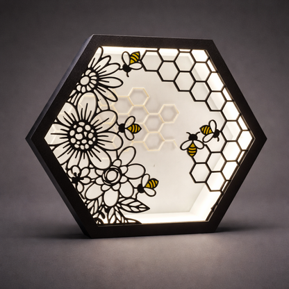Hexagonal light fixture with floral and bee design on a dark background