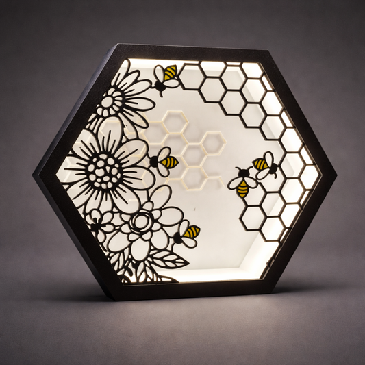 Hexagonal light fixture with floral and bee design on a dark background