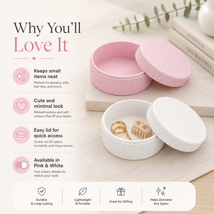 Two round screw-on jewelry boxes shown on a light beige background, one pink and one white, with the pink lid open to reveal small rings inside. Text on the left lists benefits, and books and a sprig of greenery appear in the background.