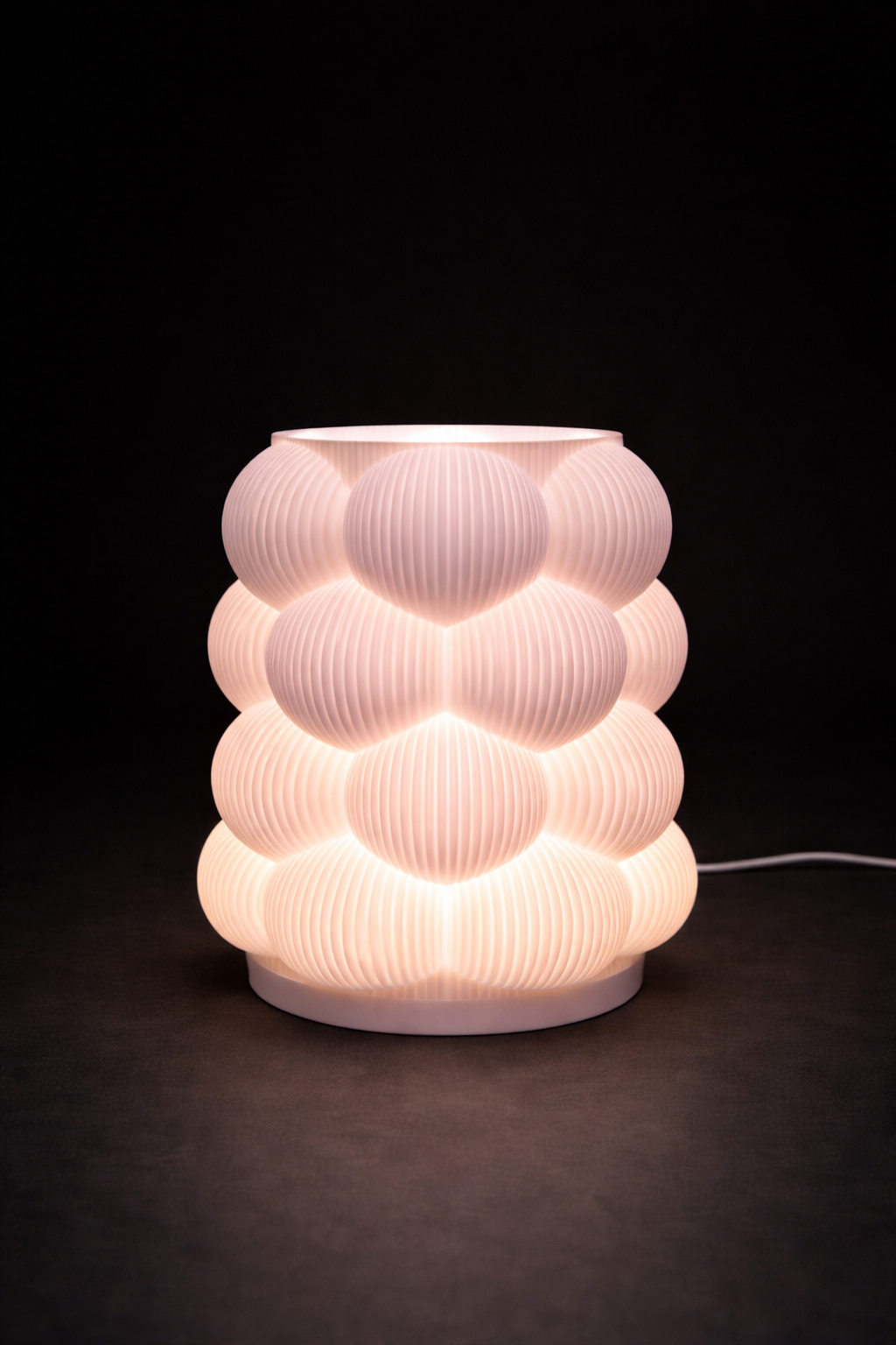 Decorative table lamp with a ribbed design on a dark background