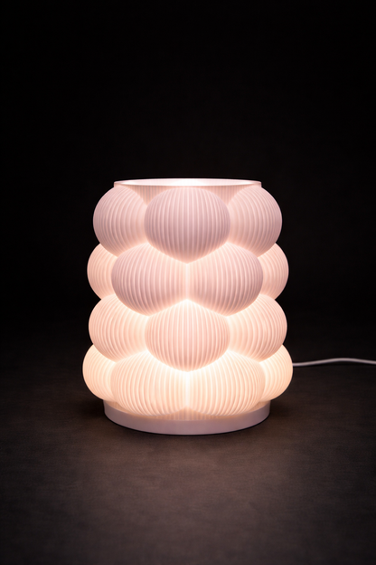 Decorative table lamp with a ribbed design on a dark background