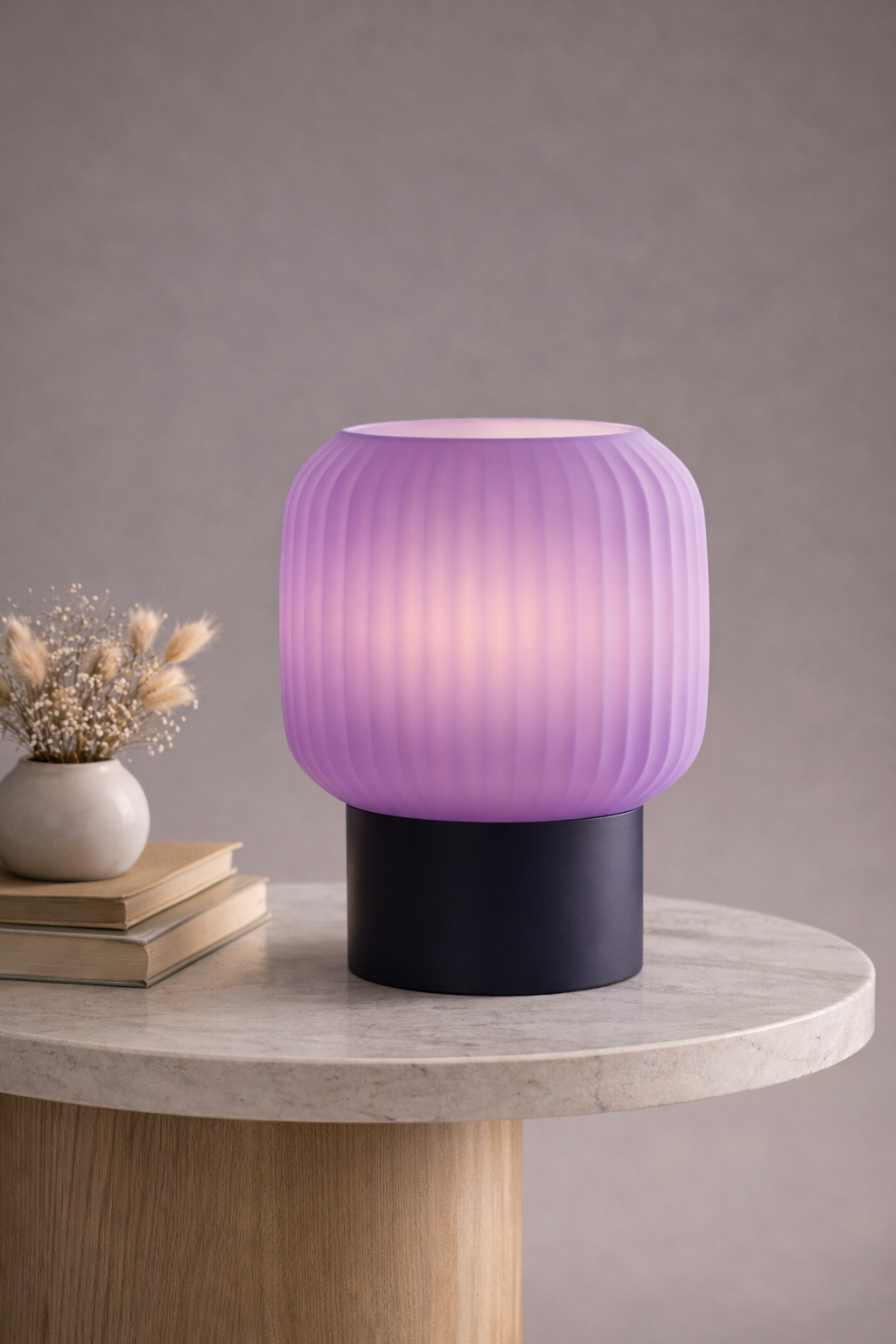 Purple table lamp on a round marble table with a neutral background