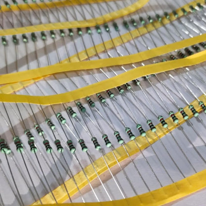 Close-up of resistors with yellow bands on a gray background