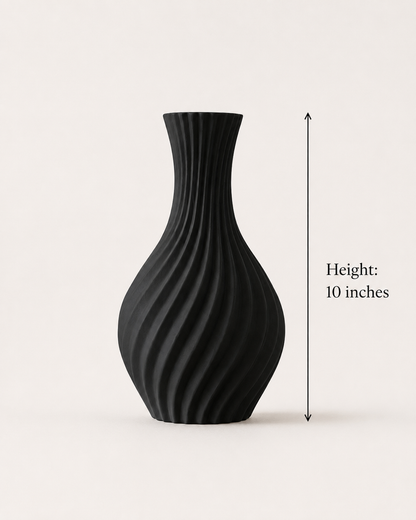 A matte black ribbed vase with a flared neck and bulbous base, shown on a light beige background with a vertical height marker reading 10 inches.