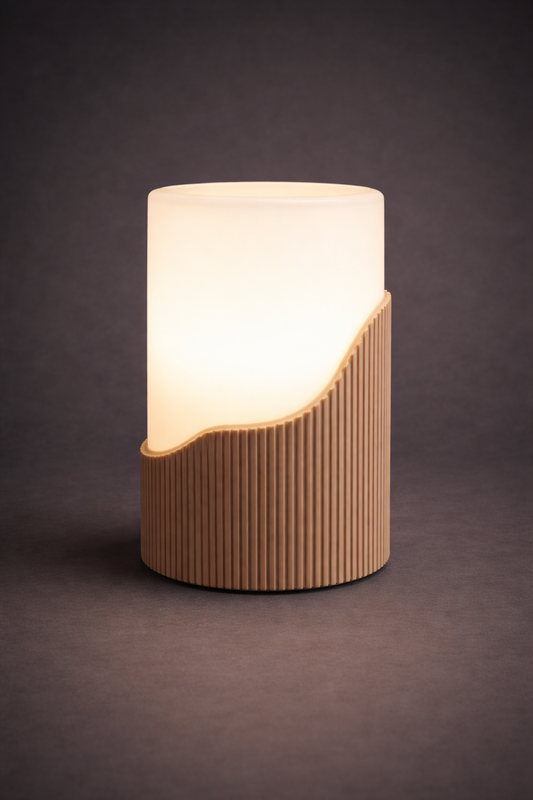 Table lamp with a ribbed beige base and white shade on a dark background