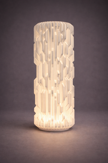 Cylindrical textured lamp with warm glow on a dark background