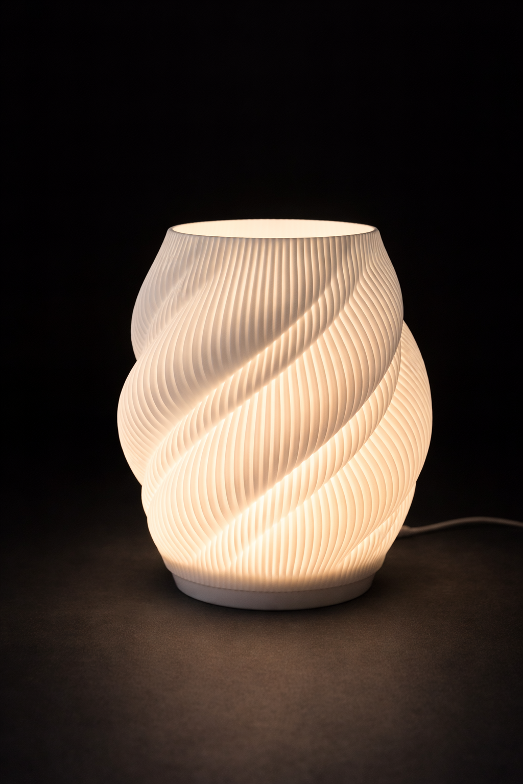 Twisted ceramic lamp with warm glow on a dark background